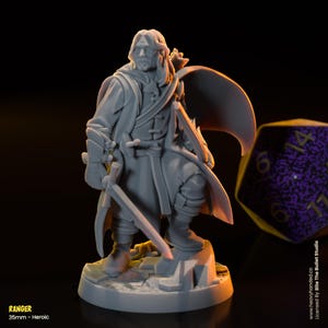 May include: A gray 35mm miniature figure of a ranger, holding a sword and bow, standing on a rocky base. The figure is wearing a long coat and has a determined expression.