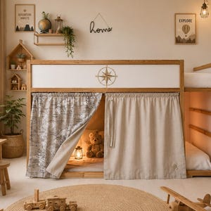 May include: A wooden bunk bed with a map-printed curtain and a neutral-colored curtain. The bed has a compass rose design and the word "home" on the wall. A teddy bear and a small lamp are inside the lower bunk. A wooden airplane and train set are on the floor.