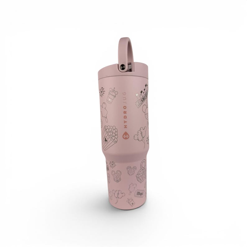 May include: A dusty rose-colored HydroJug tumbler featuring a vertical logo and various line-art illustrations including popcorn, balloons, and mouse-ear silhouettes. The drink container has a matching lid with a sturdy integrated carrying handle.