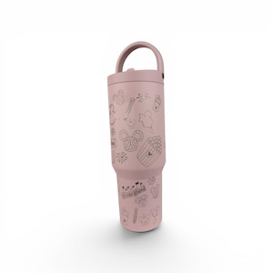 May include: A dusty rose-colored insulated tumbler with a handle on the lid, featuring a repeating pattern of etched line art icons including Mickey Mouse ears, popcorn, churros, fireworks, and the word Disneyland in a classic gothic font.