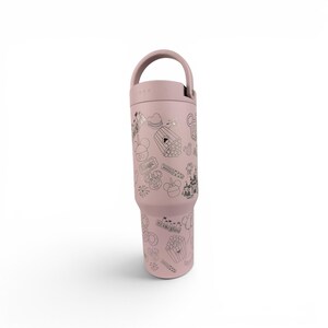 May include: A dusty rose-colored insulated tumbler with a handle on the lid. The exterior features a repeating pattern of dark gray line art illustrations including a castle, popcorn, balloons, and the text Disneyland and Magic.