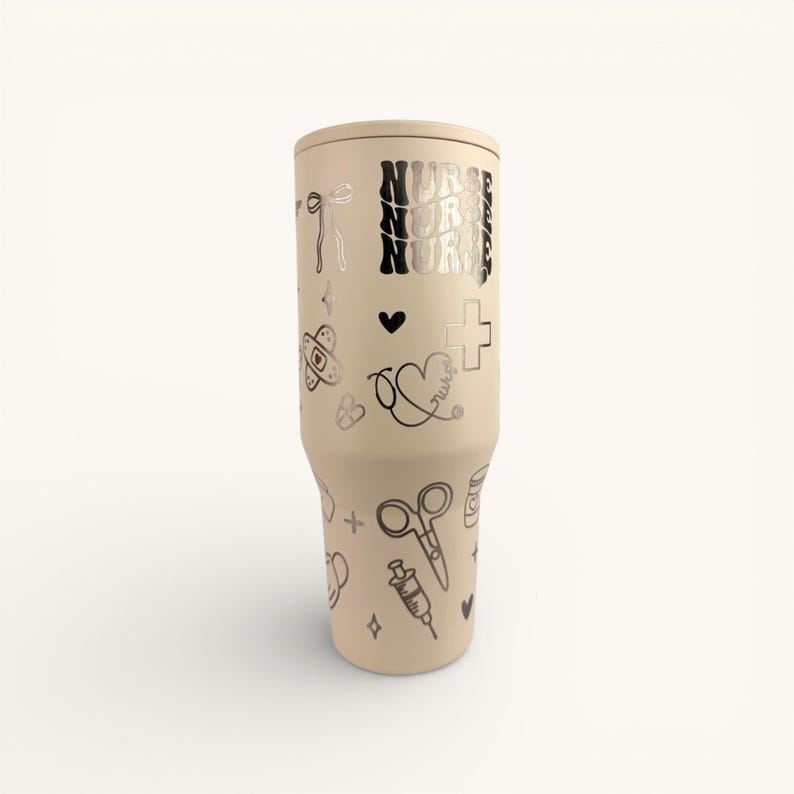 May include: A beige tumbler with a lid, adorned with black medical-themed doodles and the word "NURSE" in a stacked design. The tumbler features a variety of illustrations, including a heart, cross, scissors, and syringe.