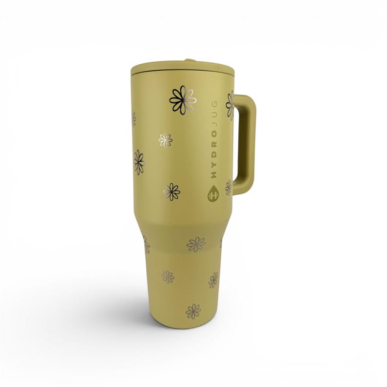 May include: A matte olive green insulated tumbler with a handle and a lid. The exterior features a repeating pattern of small, dark-colored flower icons. The text HYDRO JUG is printed vertically on the side, accompanied by a small water drop logo.