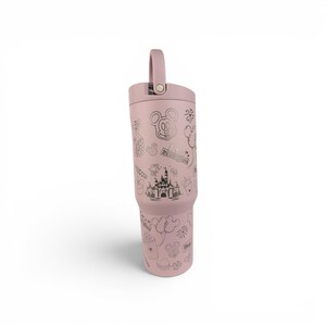 May include: A dusty rose-colored stainless steel tumbler with a matching lid and a top handle. The exterior features dark gray line art illustrations of a castle, Mickey Mouse ears, balloons, fireworks, and the text Disneyland in a repeating pattern.