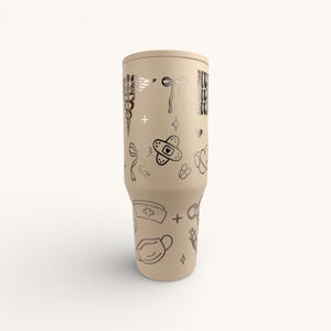 May include: A set of three ceramic mugs with a speckled, matte finish. Each mug features a different color: light blue, cream, and gray. The mugs have a simple, modern design and a comfortable handle.