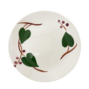 May include: A white ceramic plate with a brown and green ivy design. The plate has a slightly raised rim and is decorated with small red berries.