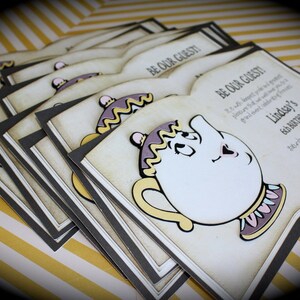 May include: A stack of invitations with a black border and a vintage-style background. The invitations feature a cartoon image of Mrs. Potts, the teapot from Disney's Beauty and the Beast, and the text "Be Our Guest!" and "Lindsey's 6th Birthday".