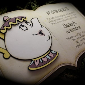 May include: A book-shaped invitation with a 3D cutout of Mrs. Potts from Beauty and the Beast. The invitation reads "Be Our Guest!" and includes details for Lindsay's 6th birthday party.