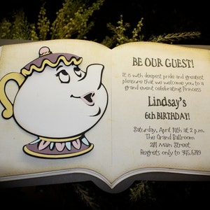 May include: A book-shaped invitation with a yellow teapot character on the front. The invitation is for Lindsay's 6th birthday party. The text reads "BE OUR GUEST!" and includes the date, time, location, and contact information for RSVPs.