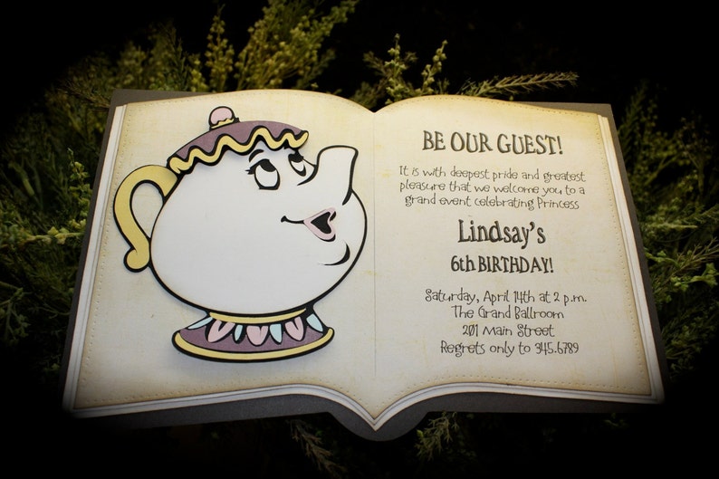 May include: A book-shaped invitation with a yellow teapot character on the front. The invitation is for Lindsay's 6th birthday party. The text reads "BE OUR GUEST!" and includes the date, time, location, and contact information for RSVPs.