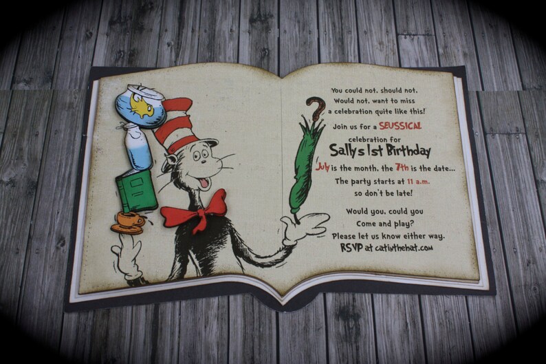 May include: A book-shaped invitation featuring an illustration of the Cat in the Hat. The invitation is for Sally's 1st birthday party, taking place on the 7th of July at 11 a.m. The text reads "You could not, should not. Would not. want to miss a celebration quite like this! Join us for a SEUSSICAL celebration for Sally's 1st Birthday July is the month, the 7th is the date.... The party starts at 11 a.m. so don't be late! Would you, could you Come and play? Please let us know either way. RSVP at cativthehat.com"