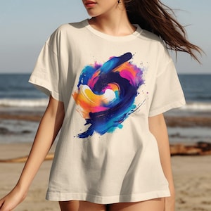 鮮やかな抽象アートTシャツ、カラフルなペイントスプラッシュデザインTシャツ、芸術的なグラフィックプリントシャツ、ユニークな芸術的なアパレル、トレンディなカジュアルウェア