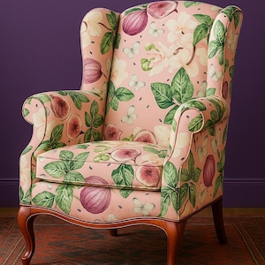 May include: Wingback armchair with a pink fig and butterfly pattern. The chair has a high back, curved arms, and wooden legs. The fabric features figs, leaves, and butterflies in shades of pink, green, and white.
