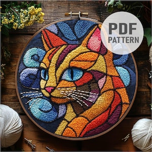 May include: A colourful embroidery pattern of a cat's face in a stained glass style. The cat's fur is orange, yellow, red and purple. The background is blue and purple.