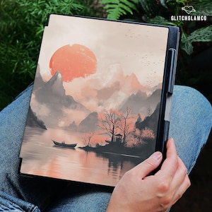 May include: A black tablet case featuring a landscape painting with a large orange sun, mountains, and a boat on the water. The artwork has a serene, watercolor style. The text "GLITCHGLAMCO" is visible in the upper right corner.