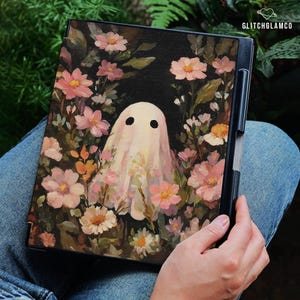 May include: A black tablet case featuring a whimsical painting of a ghost surrounded by pink and white flowers. The ghost has two black eyes and a flowing white sheet. The artwork is set against a dark background with green foliage.