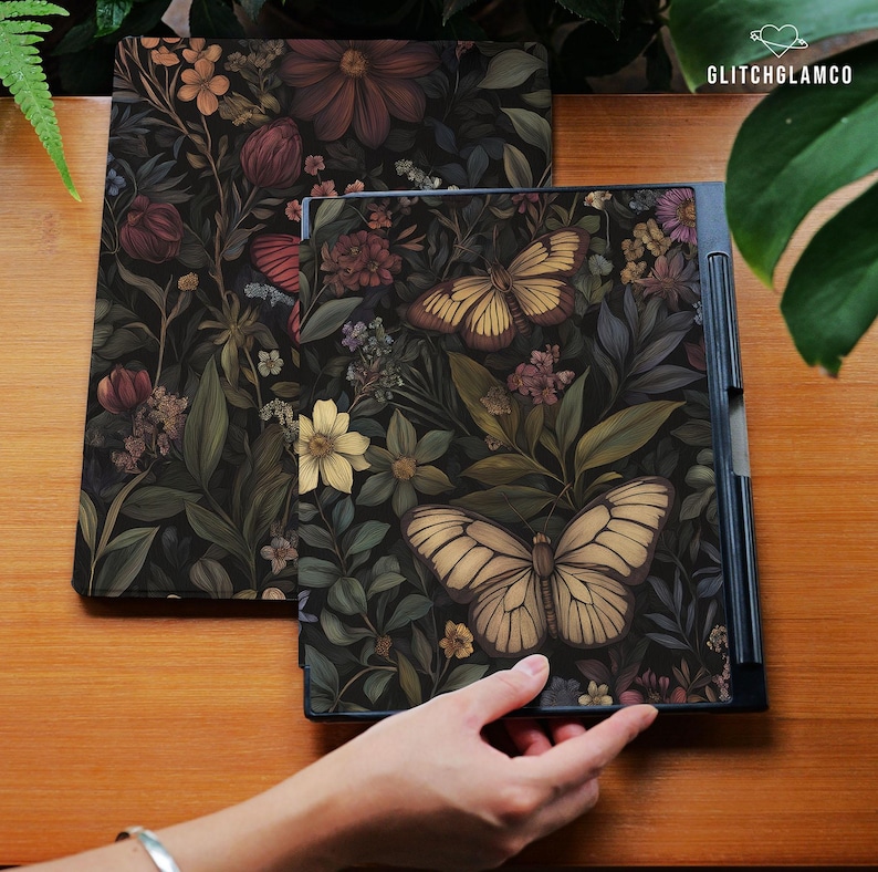 May include: Two decorative covers with a dark floral and butterfly design. One cover is open, revealing a black interior. The covers feature a variety of flowers and butterflies in shades of yellow, brown, and green.