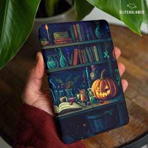 May include: A phone case featuring a Halloween-themed illustration. The design includes a bookshelf with books, potion bottles, a lit candle, and a carved pumpkin. The background is a dark blue with a starry night sky.