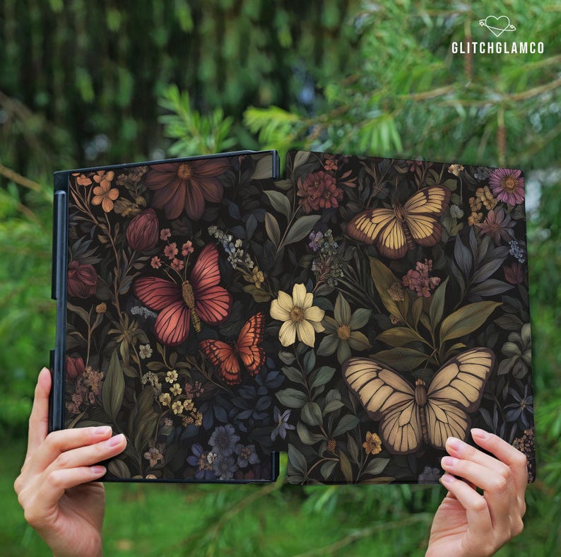 May include: Two open, dark-colored panels with a floral and butterfly design. The panels feature a variety of flowers in shades of red, yellow, and purple, along with several butterflies. The text "GLITCHGLAMCO" is in the upper right corner.