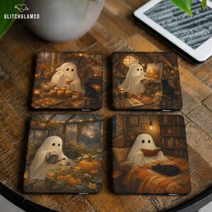 May include: A set of four square coasters featuring illustrations of a white ghost and a black cat. Scenes include the ghost baking cupcakes, painting a pumpkin, watering a garden, and reading a book in a library. Each coaster has a warm, autumnal color palette.