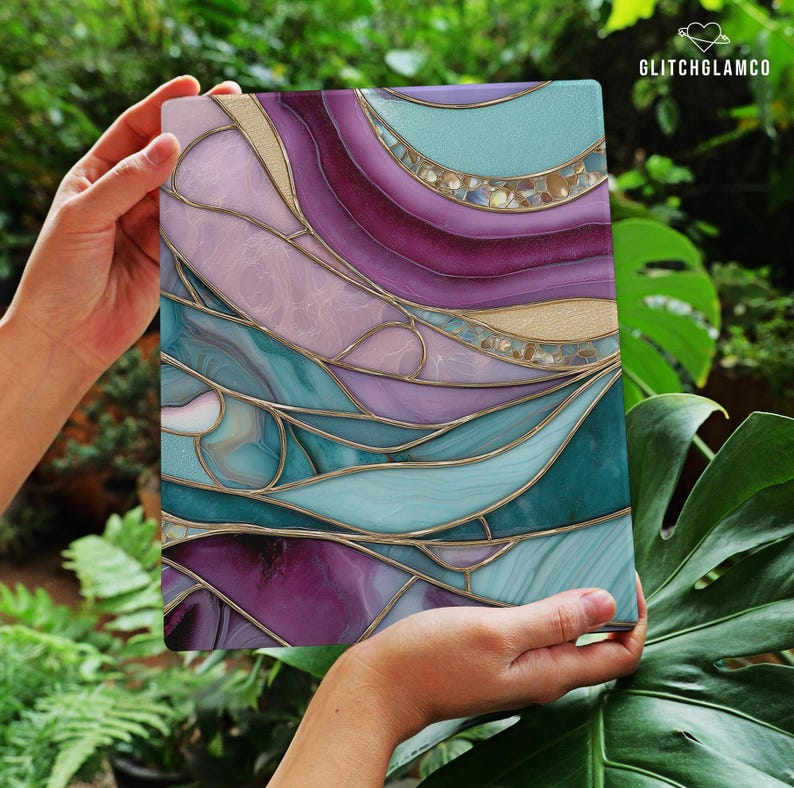 May include: A rectangular decorative panel with a stained glass design. The panel features flowing, abstract shapes in shades of purple, teal, and gold. The design is framed with gold-colored lines, and the panel is held by two hands.