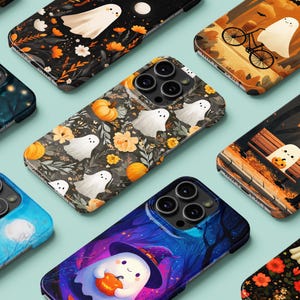 May include: A collection of phone cases with Halloween-themed designs. The cases feature illustrations of ghosts, pumpkins, and autumn foliage. The color palette includes orange, black, and blue, creating a festive and spooky aesthetic.