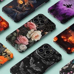 May include: A collection of phone cases with various designs. Some cases feature Halloween themes like pumpkins and haunted houses. Others showcase floral patterns, bats, and a witch flying across a purple sky. The cases have a glossy finish.