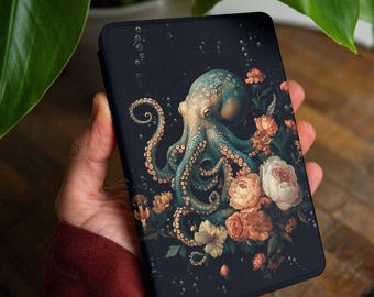 May include: A black phone case featuring a teal octopus surrounded by peach and white flowers. The octopus has detailed tentacles and is set against a dark background with bubbles. The text "GLITCHGLAMCO" is in the upper right corner.