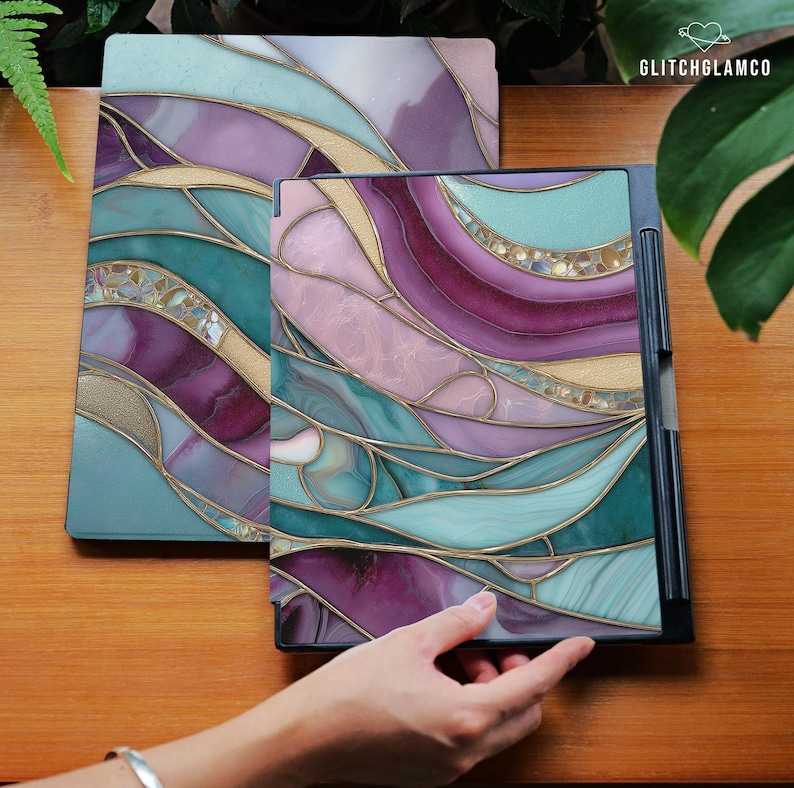 May include: Two decorative tablet covers with a stained glass design. The covers feature a flowing pattern of teal, purple, pink, and gold, with a black frame. The GlitchGlamco logo is visible in the top right corner.