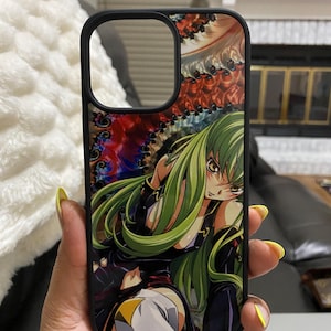 May include: Black phone case featuring a colorful anime illustration of a female character with long green hair. The case has a black border and a cutout for the camera.