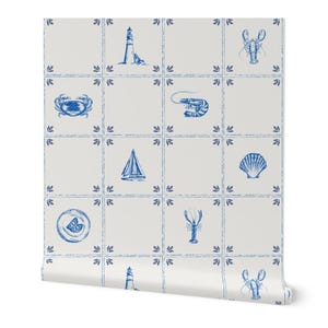 May include: White wallpaper roll with a repeating pattern of blue nautical illustrations. The design includes images of a lighthouse, crab, shrimp, sailboat, seashell, lobster, and a plate with a lemon slice.
