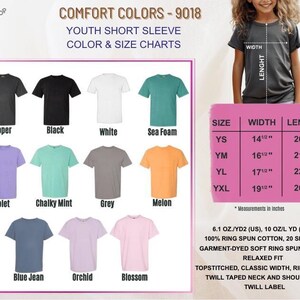 May include: A color chart for youth short sleeve t-shirts. The chart displays various shirt colors, including black, white, sea foam, violet, and grey. A size chart shows measurements in inches for youth sizes.