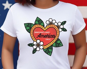 May include: White t-shirt with a red heart graphic that says "Immigrants Make America Great". The heart is surrounded by green leaves and white flowers.