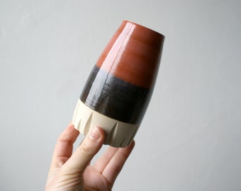 Hand thrown small pottery vase with red and black bands