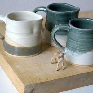 Hand thrown pottery jug glazed in various colours with 400 ml capacity