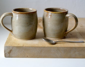 Set of two cozy stoneware pottery tea mugs glazed in glossy grey