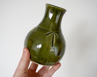 Ceramic bottle shaped vase in green with hand carved details