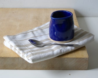 Hand thrown mini cafe style milk jug in a dark blue glossy glaze