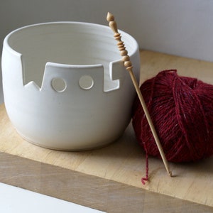 The front of a wool yarn bowl glazed in vanilla cream