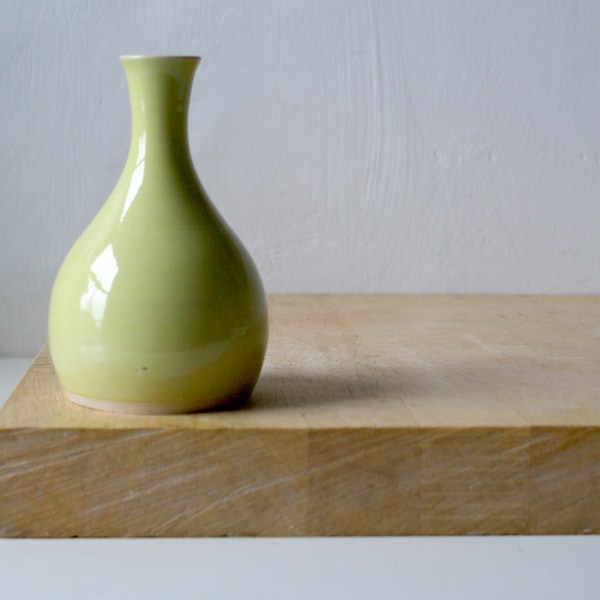 Hand thrown ceramic bottle bud vase glazed in yellow made with white stoneware clay