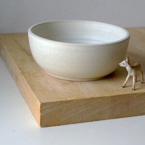Each hand thrown salad bowl is turned with a foot ring on the bottom which can be seen in this profile view