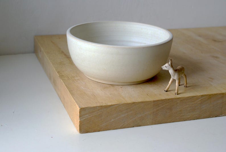 Each hand thrown salad bowl is turned with a foot ring on the bottom which can be seen in this profile view