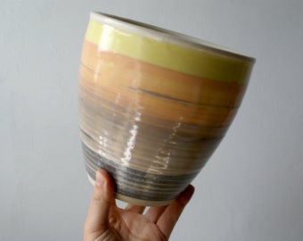 Tall decorative pottery bowl with warm glowing sunset colours