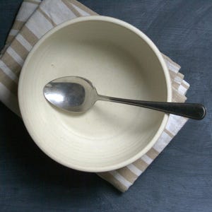 A flat lay view of a large salad bowl hand thrown stoneware pottery