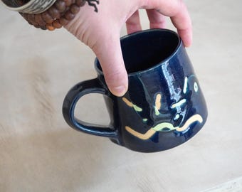 SALE - One hand thrown pottery mug in dark blue covered in doodle pattern