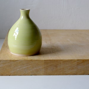 Handmade ceramic bottle vase using stoneware clay in vibrant yellow