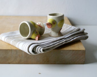 Two stoneware yellow chicken egg cups for your breakfast table