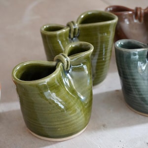 Folded stoneware squishy ceramic pouring jug for milk glazed in a variety of colours