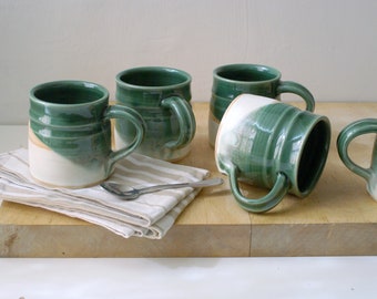 One large pottery tea mug in two tone green and cream colours