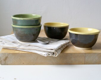 Set of two stoneware pottery snack bowls available in yellow or green